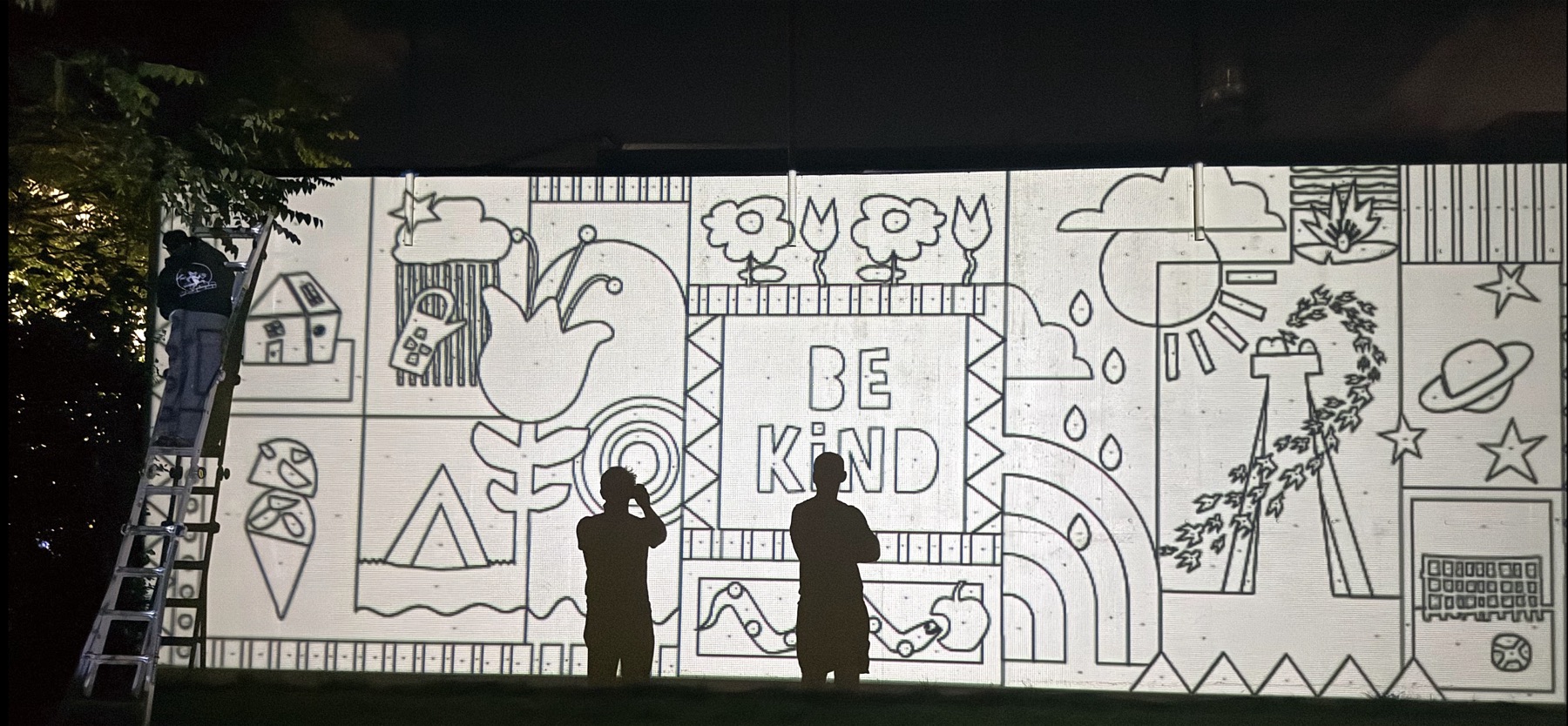 Mural stencil — 'Be Kind' going up on the wall